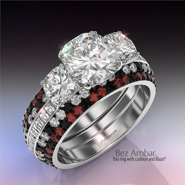 Three-stone-cushion-engagement-ring-with-black white and red bookend bands
